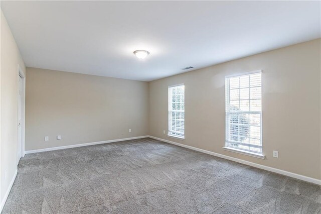 empty room featuring light carpet