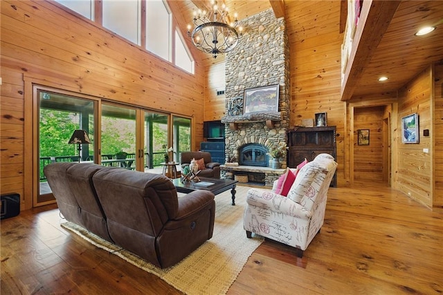 147 Lake Watch Pt, Cleveland, GA 30528 - living area with high vaulted ceiling, wooden walls, a chandelier, hardwood / wood-style floors, and a fireplace