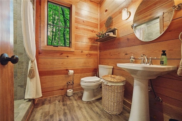 147 Lake Watch Pt, Cleveland, GA 30528 - full bathroom with wood finished floors, toilet, curtained shower, and wood walls