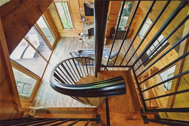 147 Lake Watch Pt, Cleveland, GA 30528 - stairway featuring wood finished floors, wooden walls, and a stone fireplace