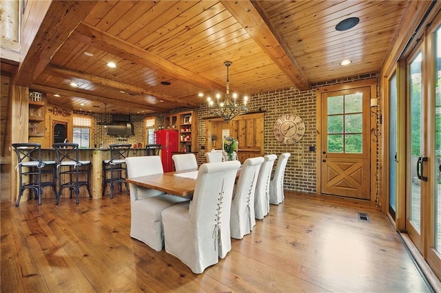 147 Lake Watch Pt, Cleveland, GA 30528 - dining area featuring light wood finished floors, wooden ceiling, a chandelier, brick wall, and beam ceiling