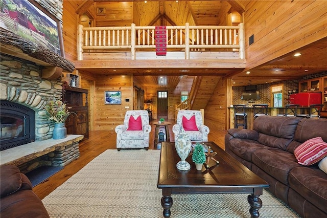 147 Lake Watch Pt, Cleveland, GA 30528 - living area with wood walls, wood finished floors, a fireplace, and a high ceiling