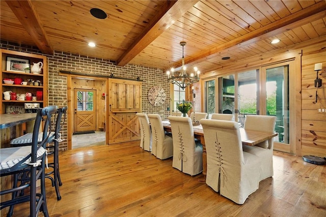 147 Lake Watch Pt, Cleveland, GA 30528 - dining space featuring a barn door, brick wall, wood ceiling, beamed ceiling, and light wood finished floors