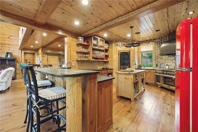147 Lake Watch Pt, Cleveland, GA 30528 - kitchen with wall chimney exhaust hood, refrigerator, open shelves, range with two ovens, and wooden ceiling