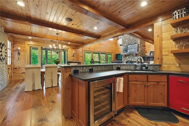 147 Lake Watch Pt, Cleveland, GA 30528 - kitchen featuring beverage cooler, a sink, hardwood / wood-style floors, dark countertops, and brown cabinetry