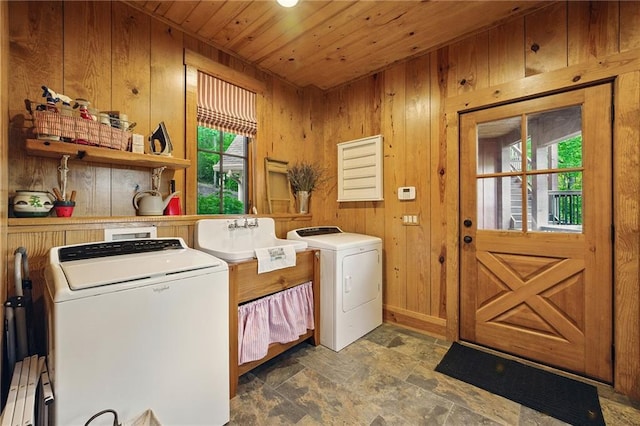 147 Lake Watch Pt, Cleveland, GA 30528 - clothes washing area with washer and clothes dryer, wood walls, wooden ceiling, stone finish floors, and a baseboard heating unit