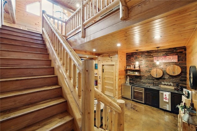 147 Lake Watch Pt, Cleveland, GA 30528 - indoor wet bar with beverage cooler, concrete floors, refrigerator, stairs, and wooden walls