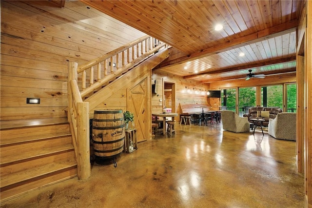 147 Lake Watch Pt, Cleveland, GA 30528 - living room with stairway, wood ceiling, concrete floors, wooden walls, and a ceiling fan