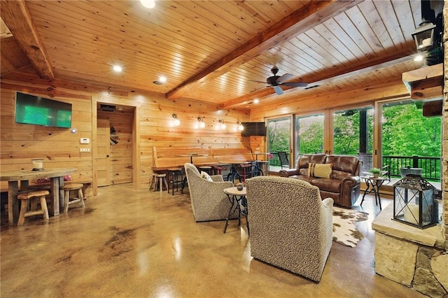 147 Lake Watch Pt, Cleveland, GA 30528 - living area with finished concrete floors, beamed ceiling, wood ceiling, wood walls, and ceiling fan