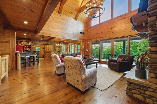 147 Lake Watch Pt, Cleveland, GA 30528 - living area featuring a chandelier, a towering ceiling, healthy amount of natural light, wooden walls, and hardwood / wood-style floors