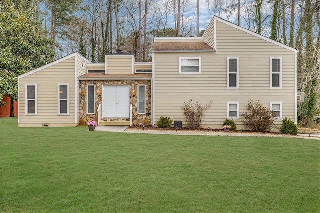 view of front of home with stone siding and a front yard