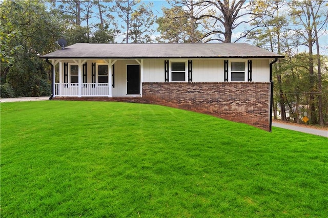 ranch-style house with a porch and a front lawn