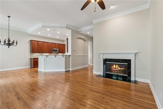5882 Riverstone Cir Unit 15, Atlanta, GA 30339 - unfurnished living room with ornamental molding, ceiling fan, recessed lighting, a lit fireplace, and light wood finished floors