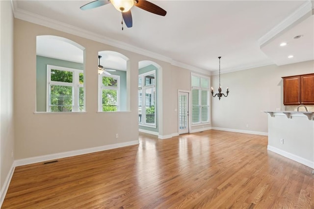 5882 Riverstone Cir Unit 15, Atlanta, GA 30339 - unfurnished living room featuring ceiling fan, light wood-type flooring, baseboards, arched walkways, and ornamental molding