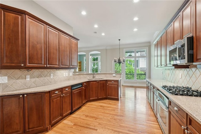 5882 Riverstone Cir Unit 15, Atlanta, GA 30339 - kitchen with appliances with stainless steel finishes, a chandelier, light wood-style floors, ornamental molding, and recessed lighting