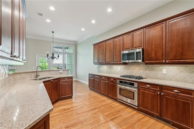 5882 Riverstone Cir Unit 15, Atlanta, GA 30339 - kitchen featuring appliances with stainless steel finishes, a sink, light stone counters, backsplash, and a chandelier