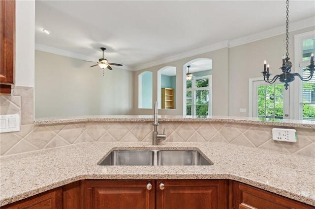 5882 Riverstone Cir Unit 15, Atlanta, GA 30339 - kitchen featuring a sink, ceiling fan, light stone counters, healthy amount of natural light, and ornamental molding