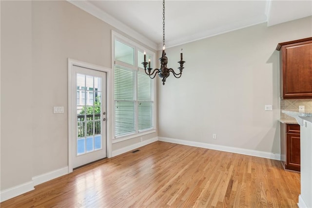 5882 Riverstone Cir Unit 15, Atlanta, GA 30339 - unfurnished dining area with a chandelier, light wood finished floors, crown molding, and baseboards