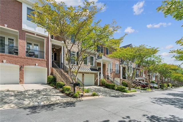 5882 Riverstone Cir Unit 15, Atlanta, GA 30339 - view of property with a residential view, an attached garage, concrete driveway, brick siding, and a standing seam roof