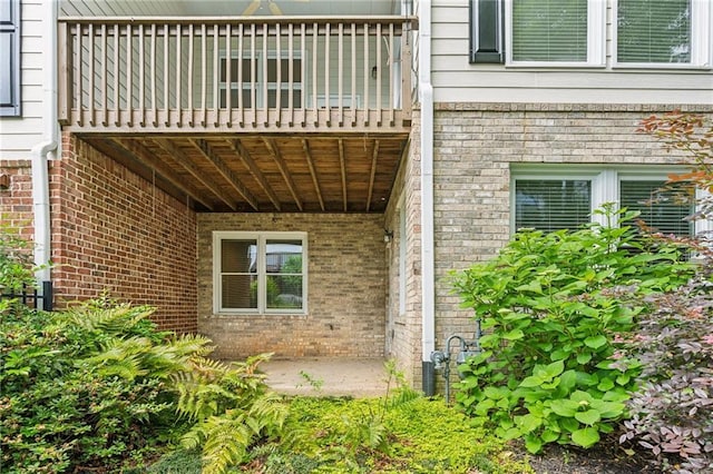 5882 Riverstone Cir Unit 15, Atlanta, GA 30339 - doorway to property featuring brick siding and a balcony