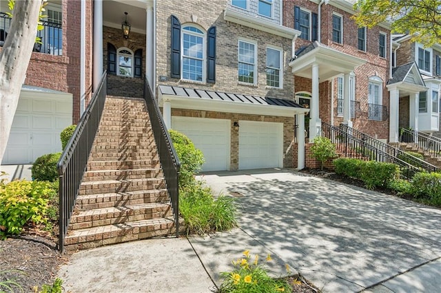 5882 Riverstone Cir Unit 15, Atlanta, GA 30339 - view of front of home featuring stairway, driveway, an attached garage, and brick siding