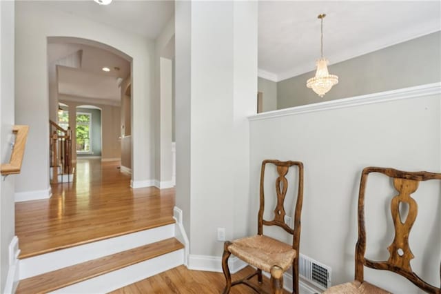 5882 Riverstone Cir Unit 15, Atlanta, GA 30339 - corridor featuring arched walkways, wood finished floors, a chandelier, and baseboards