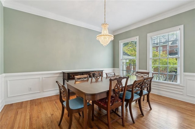 5882 Riverstone Cir Unit 15, Atlanta, GA 30339 - dining area with a chandelier, wood finished floors, a wainscoted wall, ornamental molding, and a decorative wall