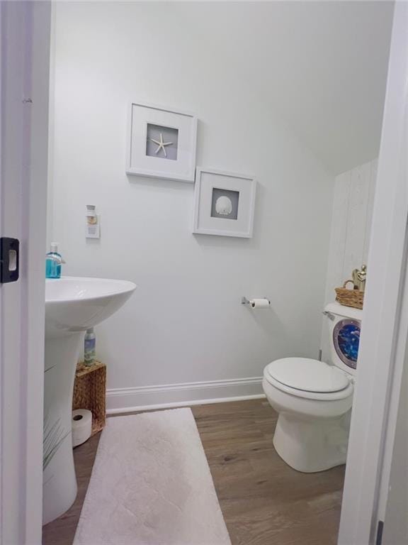 bathroom with toilet and wood-type flooring