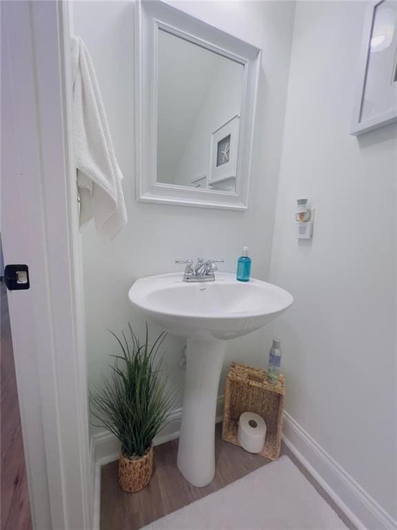 bathroom with sink and hardwood / wood-style floors