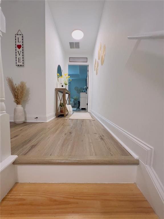 corridor with hardwood / wood-style floors