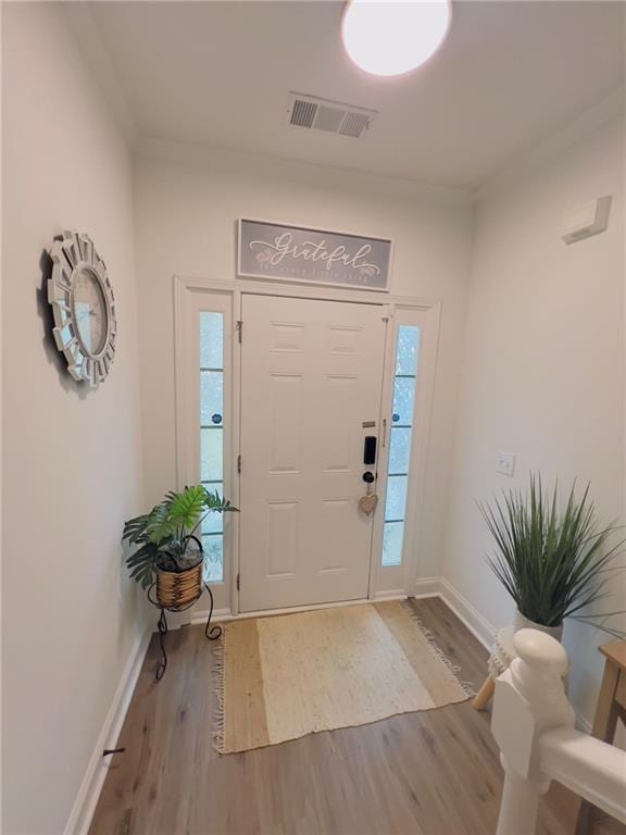 foyer entrance with light hardwood / wood-style floors