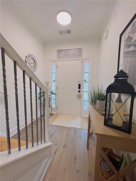 entryway with hardwood / wood-style floors