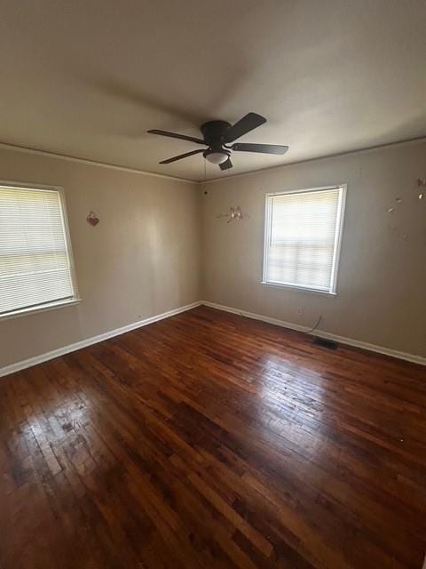 spare room featuring baseboards, wood-type flooring, and ceiling fan