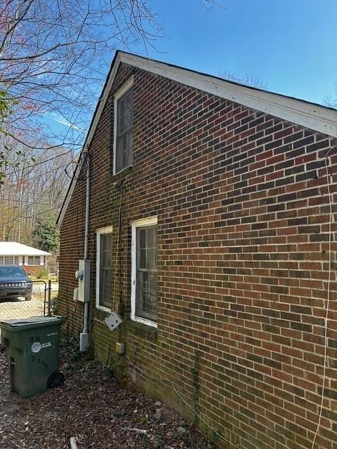 view of side of property featuring brick siding