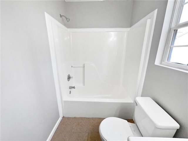 bathroom with toilet and shower / bathing tub combination