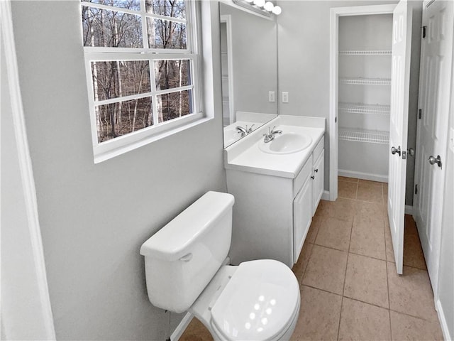 bathroom featuring vanity, tile patterned flooring, and toilet