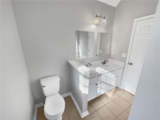 bathroom with vanity, tile patterned floors, and toilet