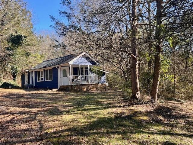 view of property exterior featuring covered porch