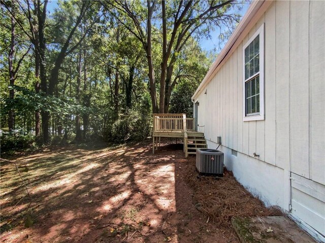 view of yard with cooling unit and a wooden deck