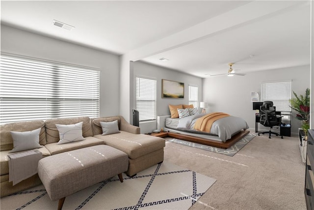 bedroom with ceiling fan and light carpet