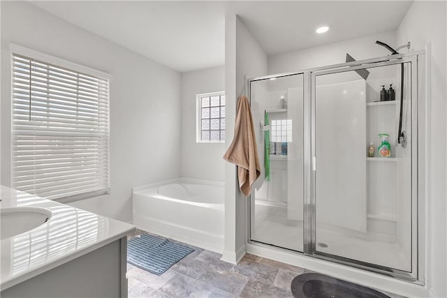 bathroom featuring vanity and shower with separate bathtub