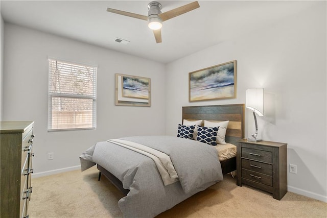 bedroom featuring ceiling fan and light carpet