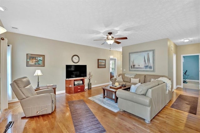 17 Sassafras Trl NE, Cartersville, GA 30121 - living room featuring light wood-style flooring, ceiling fan, and a textured ceiling