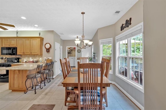 17 Sassafras Trl NE, Cartersville, GA 30121 - dining room with washer / clothes dryer, light tile patterned flooring, a chandelier, a textured ceiling, and a ceiling fan