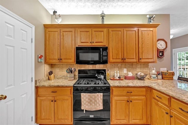 17 Sassafras Trl NE, Cartersville, GA 30121 - kitchen featuring black appliances, a textured ceiling, backsplash, light stone counters, and brown cabinets