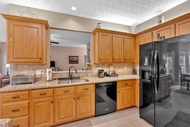 17 Sassafras Trl NE, Cartersville, GA 30121 - kitchen featuring black appliances, a textured ceiling, tasteful backsplash, light tile patterned flooring, and light stone countertops