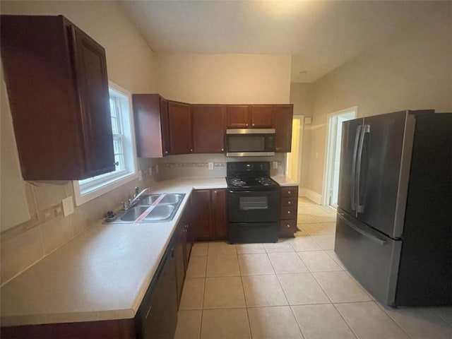 kitchen featuring tasteful backsplash, sink, stainless steel appliances, and light tile patterned flooring