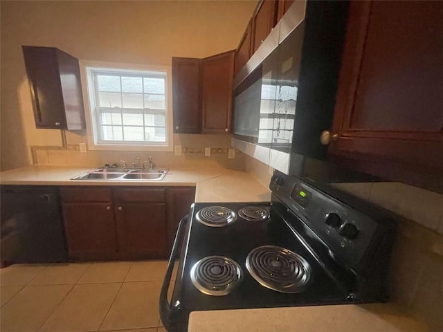 kitchen with sink, light tile patterned floors, and black electric range