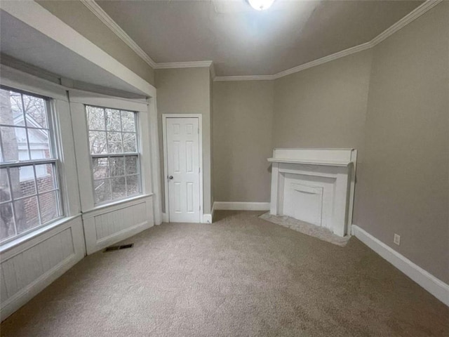 unfurnished living room with ornamental molding and light carpet