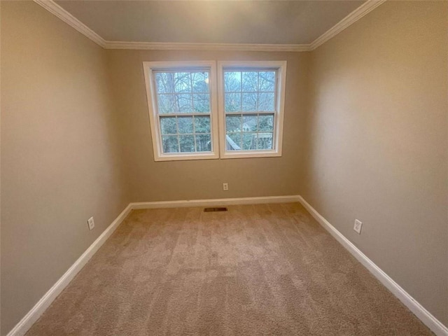 unfurnished room featuring crown molding and light colored carpet